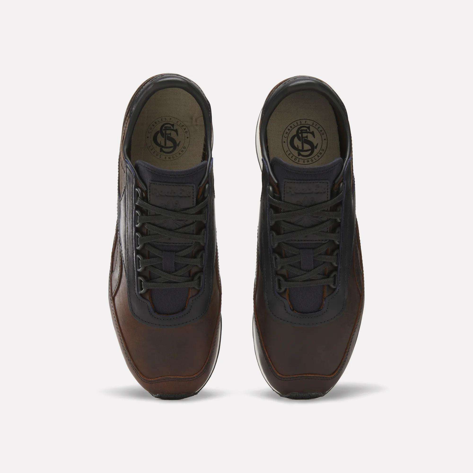 The Reebok Camargue x C.F. Stead Shoes feature brown full-grain leather, black laces, and dark mesh accents, shown from above on a plain light background.