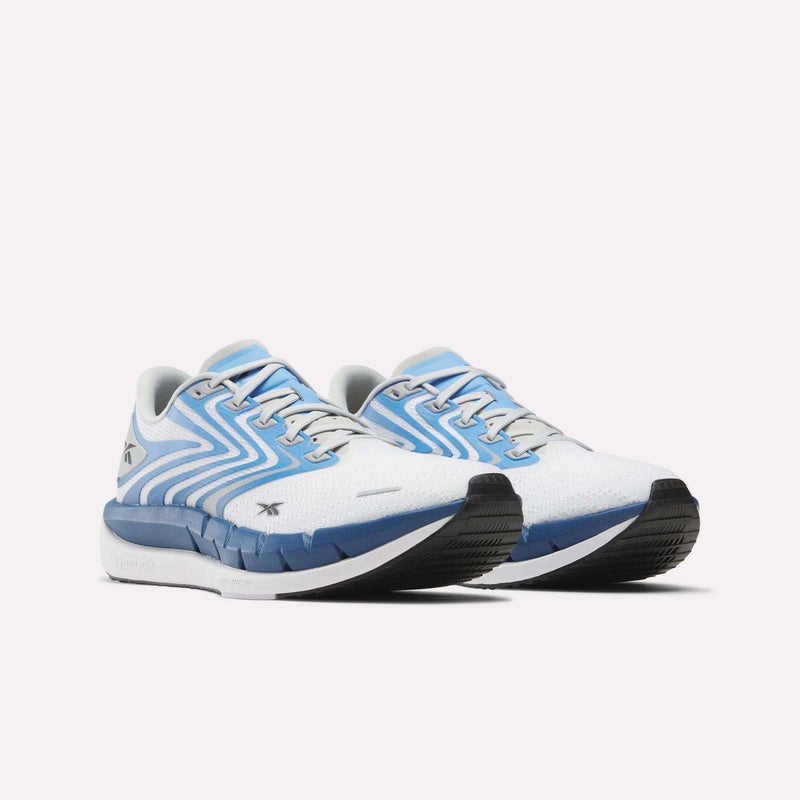 The Reebok Men's FloatZig Tread Running Shoes in white with light blue and navy accents feature a zigzag side pattern and dual-density midsole, ideal for treadmill workouts, shown on a white background.
