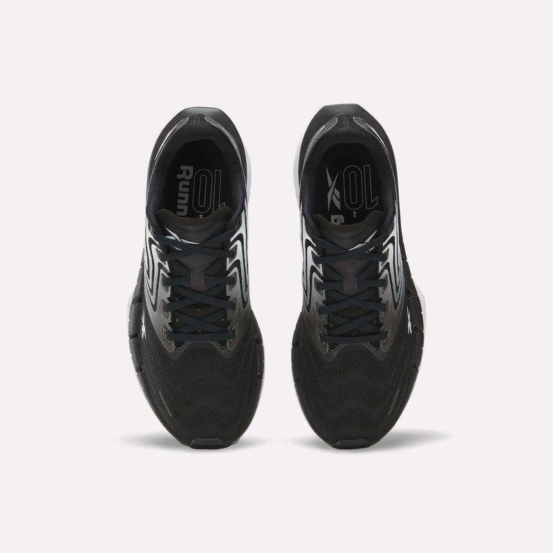 Top view of Reebok Women's FloatZig Tread Running Shoes with white accents on a white background. Features breathable mesh uppers and branded insoles, ideal for treadmill workouts.