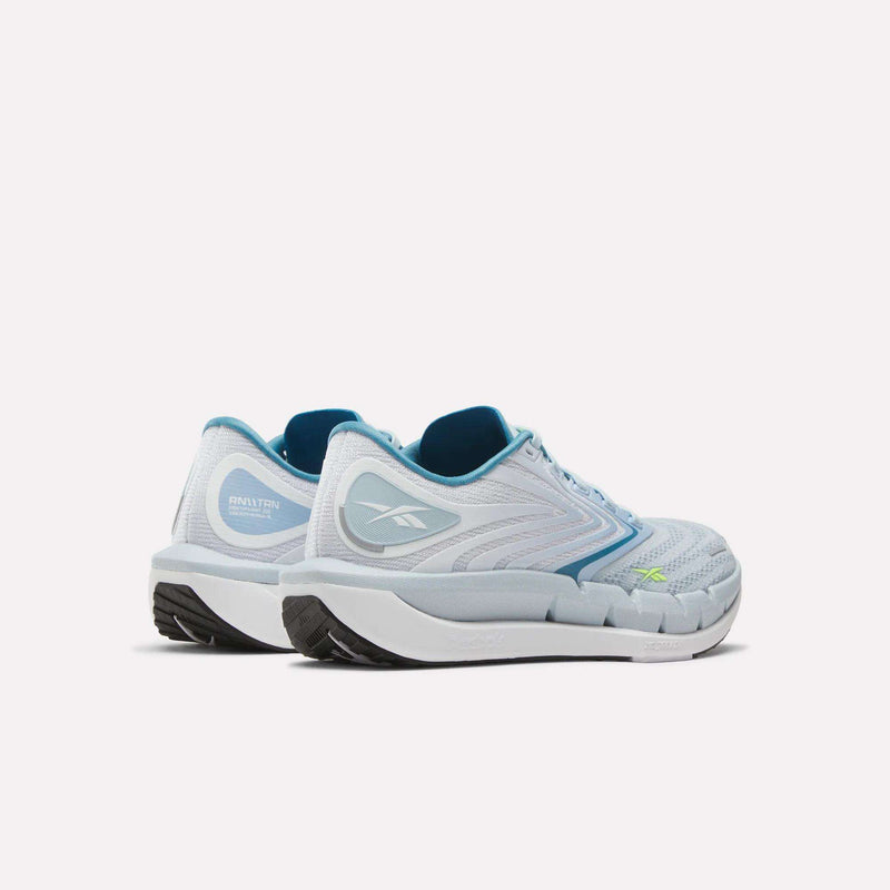A pair of Reebok Women's FloatZig Tread Running Shoes in light blue with white soles and teal accents, breathable mesh for comfort, shown angled to display the side and back on a plain white background—perfect for treadmill workouts.