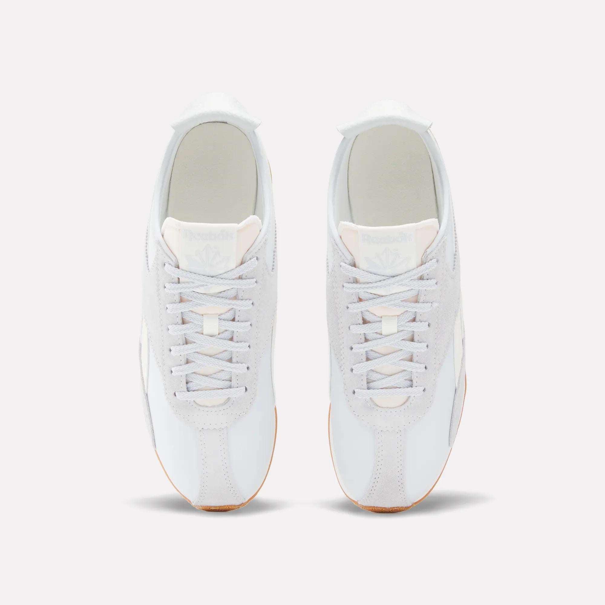 A top-down view of Reebok R400 Shoes shows the white sneakers with light gray suede accents, white laces, and tan soles, displayed side by side on a plain light background.