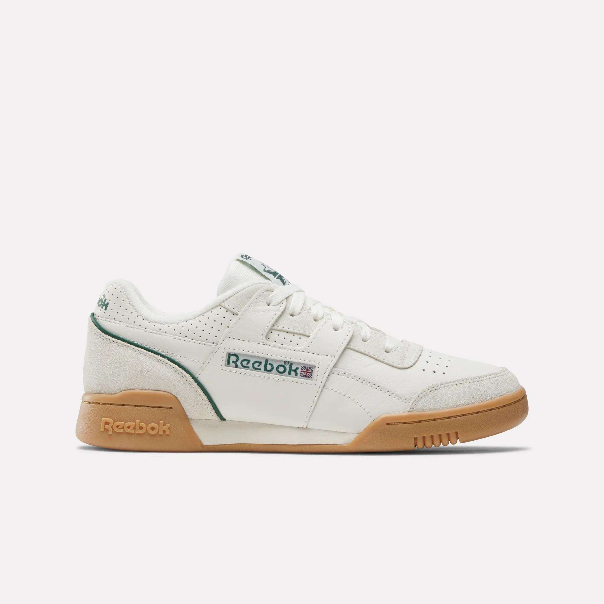 The Reebok Workout Plus Shoes in white feature a gum sole, green accents, and the Reebok logo on the side, shown in a side profile view against a plain white background for classic '80s style.