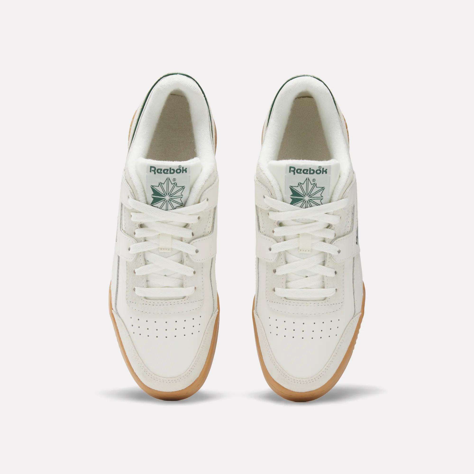 A top view of Reebok Workout Plus Shoes with white uppers, gum soles, white laces, perforated toe boxes, and green Reebok logos on the tongues—capturing classic '80s fitness style.