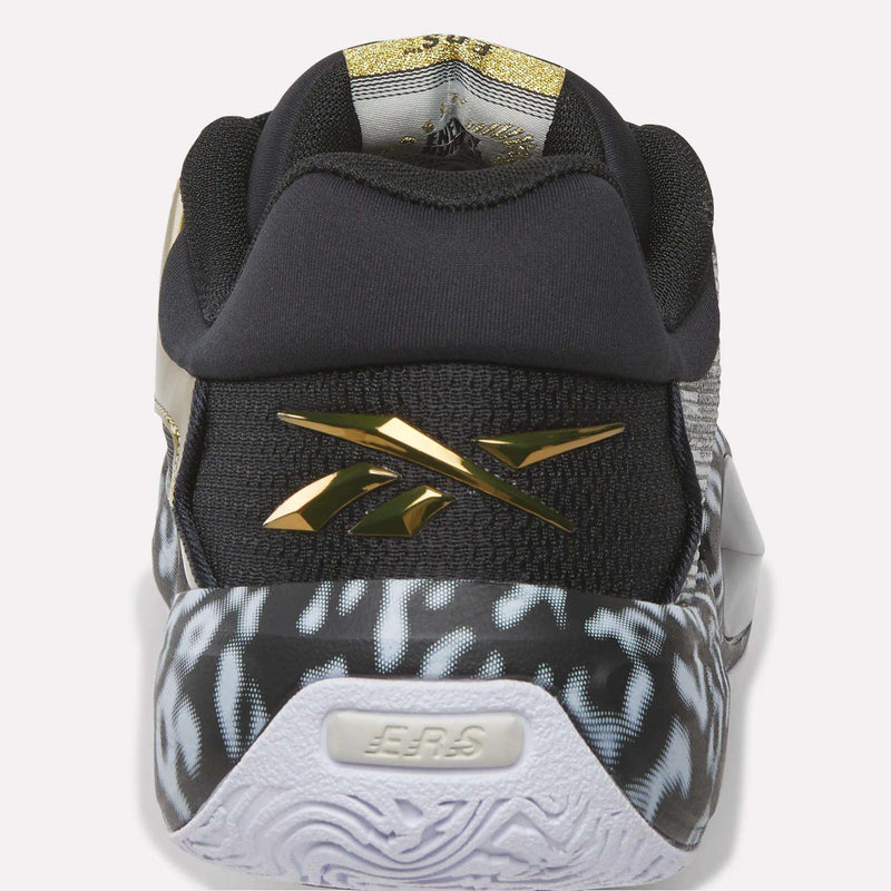 A close-up rear view of the Reebok Engine A 26 Basketball Shoes with a black upper, “EER5” text on the heel, a black and white patterned midsole, metallic gold details, gold Reebok logo, and game-changing cushioning from the ERS+ System.
