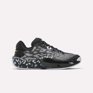 The Reebok Engine A 26 Basketball Shoes are black and white low-tops with a textured pattern, black laces, a white sole, subtle gold accents on heel and tongue, and game-changing ERS+ System cushioning.