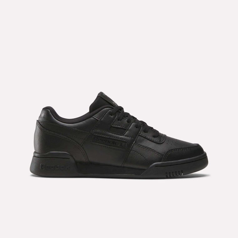 The Reebok Workout Plus Shoes - Big Kids feature a black low-top design with lace-up closure and classic Reebok branding, bringing retro style to juniors’ footwear, shown against a plain white background.