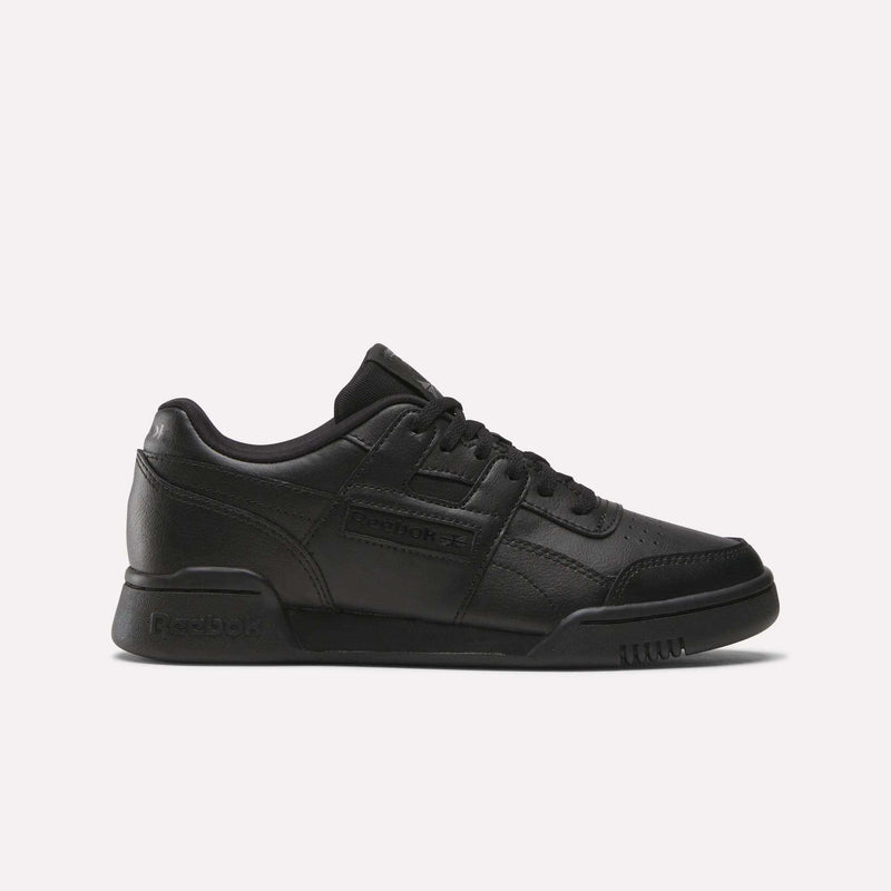The Reebok Workout Plus Shoes - Big Kids feature a black low-top design with lace-up closure and classic Reebok branding, bringing retro style to juniors’ footwear, shown against a plain white background.