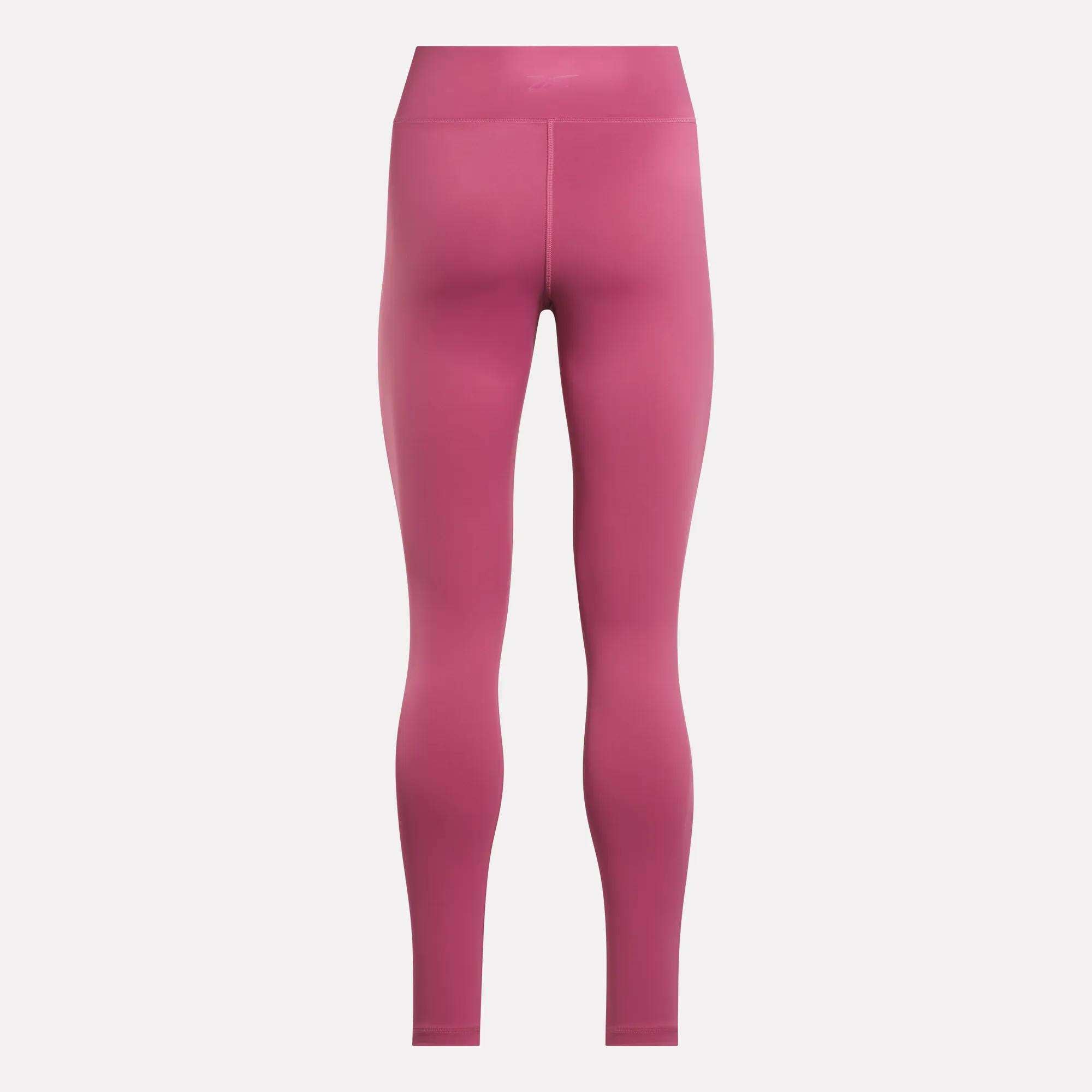 Rear view of Reebok Women's Lux-Lite High-Rise Tights in pink, full-length design, made with RBK-DRY performance fabric, displayed on a plain white background.