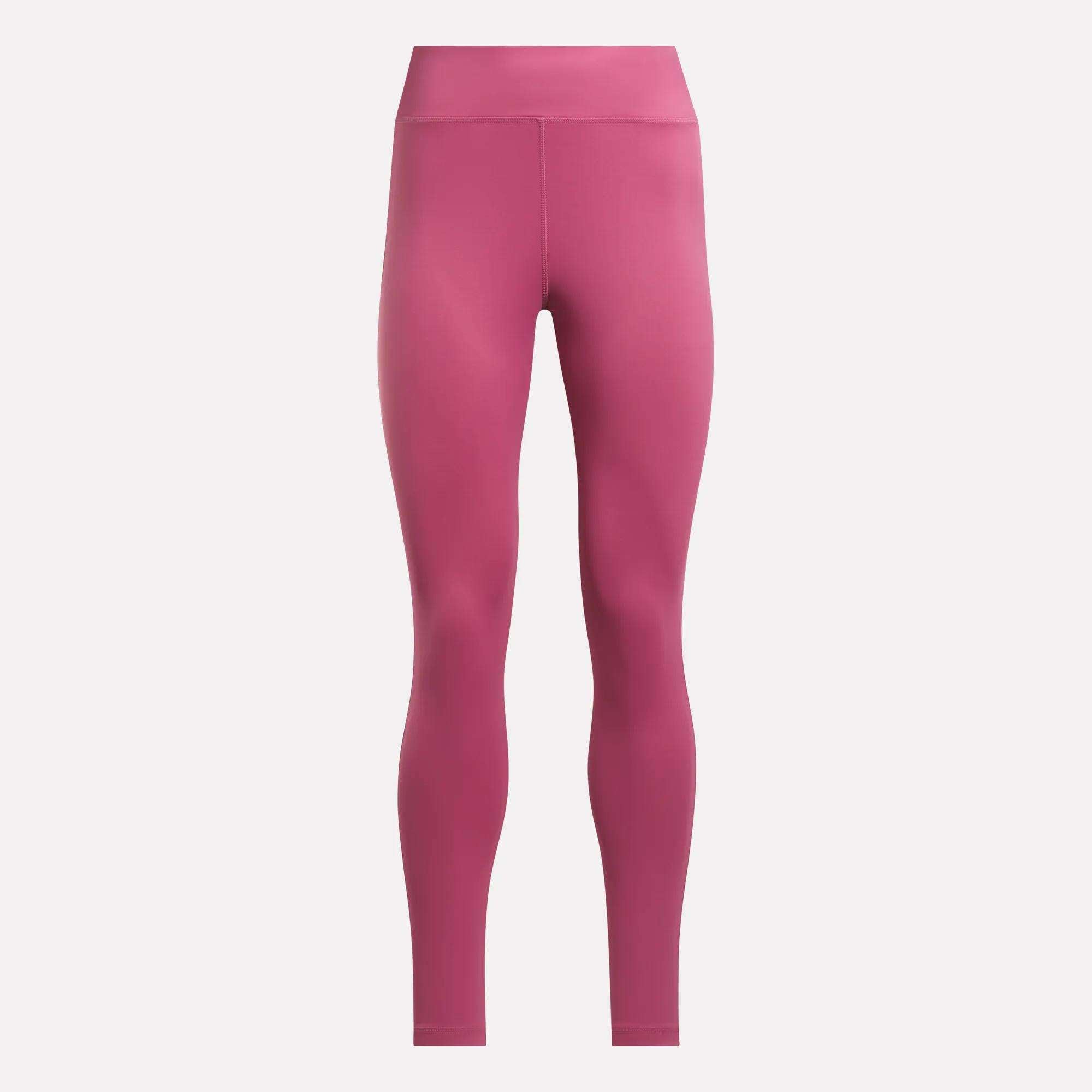 The Women's Lux-Lite High-Rise Tights by Reebok are full-length, high-waisted pink training tights made with RBK-DRY fabric, shown against a plain white background.