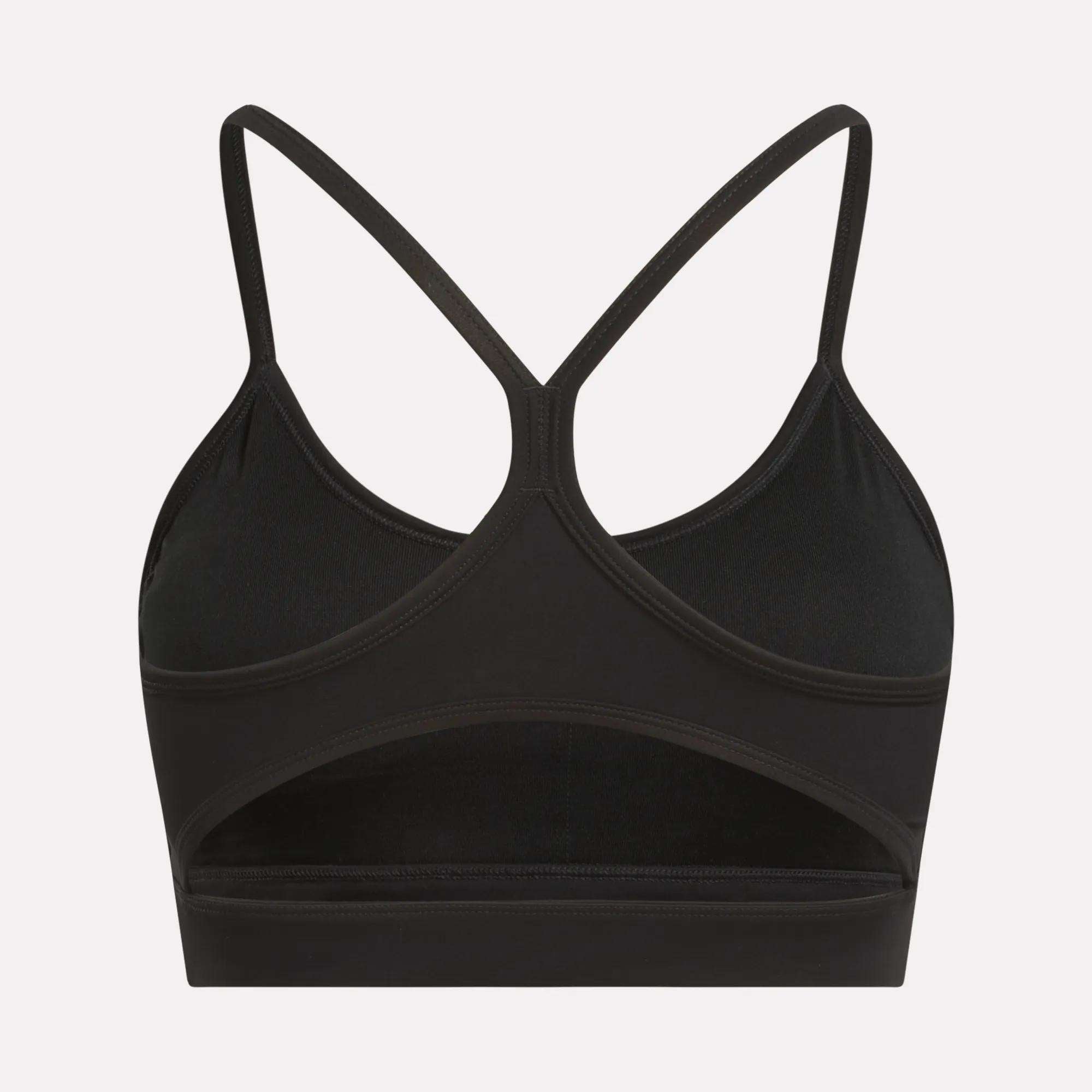 The Reebok Women's Yoga Strappy Bra features thin crisscross straps, a racerback, and a stylish cutout for ventilation and sweat-wicking comfort. This medium-support sports bra is perfect for your workouts.