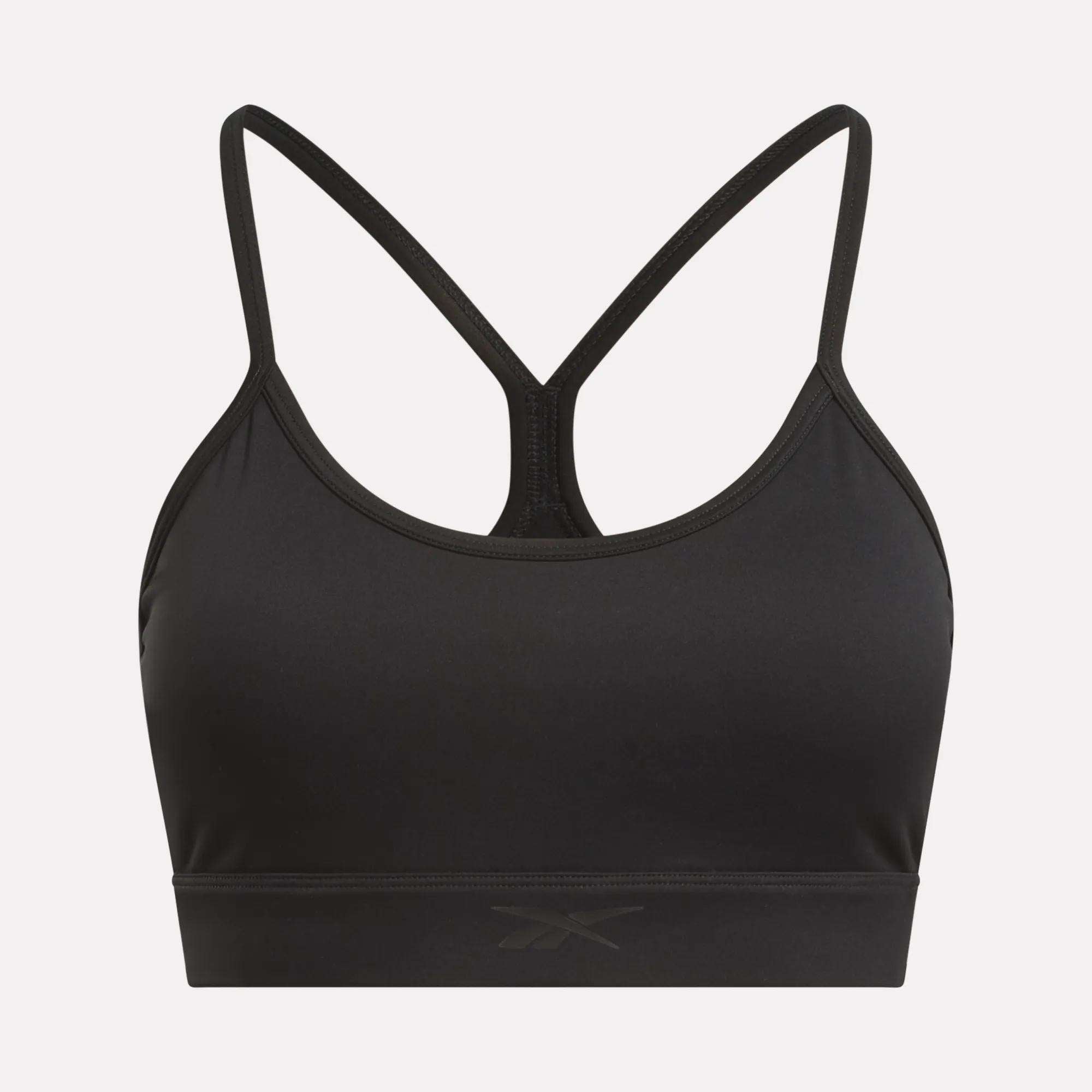 The Reebok Women's Yoga Strappy Bra features thin, crisscrossed back straps, a subtle front logo, and a sweat-wicking fitted design—perfect for athletic or casual wear.