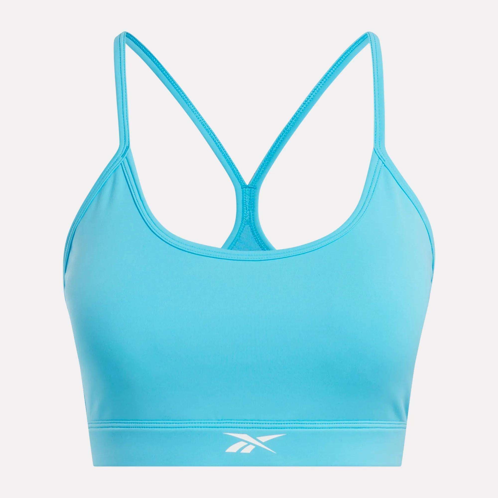 The Reebok Women's Core Strappy Bra offers medium support, featuring thin straps, a racerback design, and a white logo on the band—ideal for your workouts.