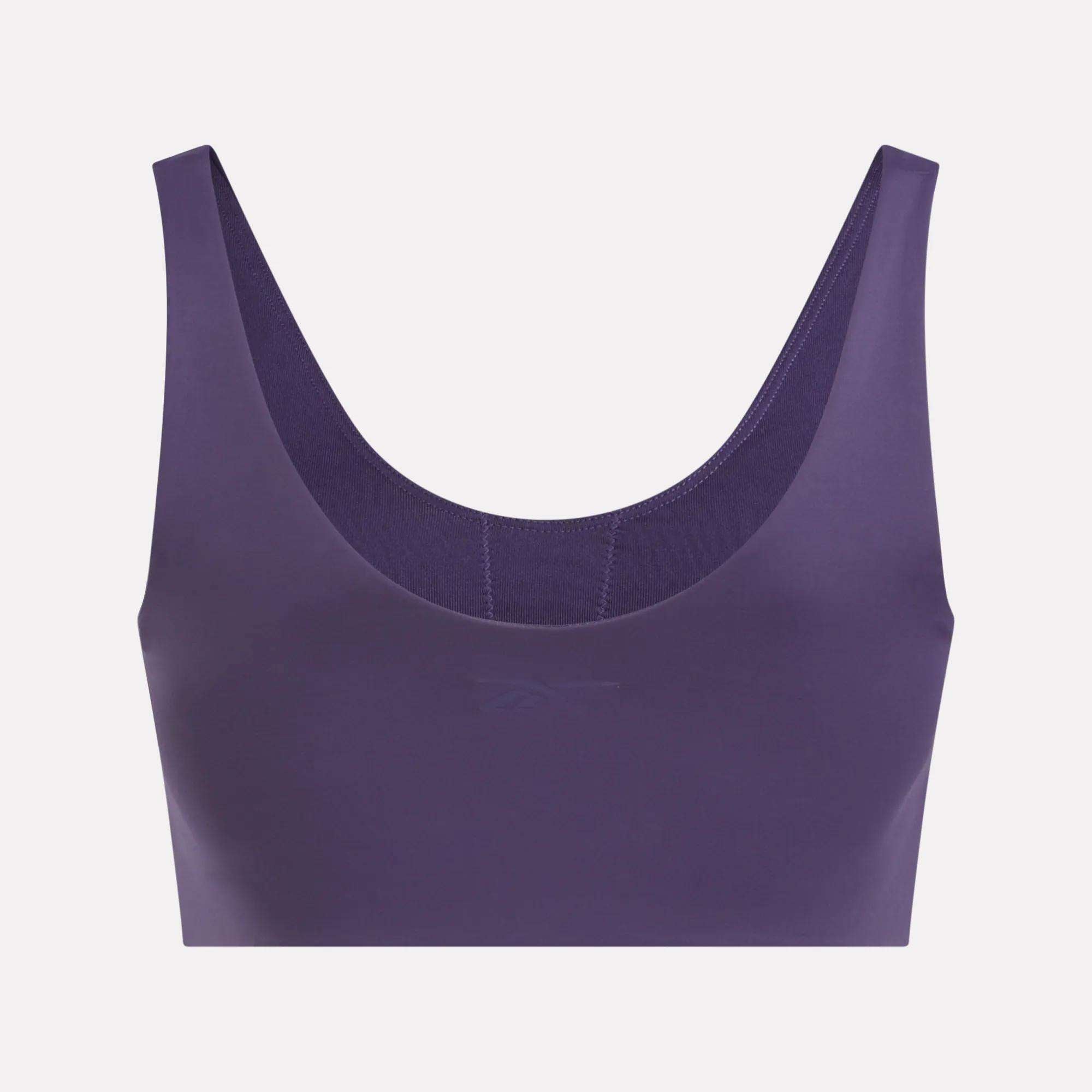The Reebok Women's Yoga V-Neck Bra in purple delivers medium-impact support and is ideal for studio workouts, shown on a plain white background.