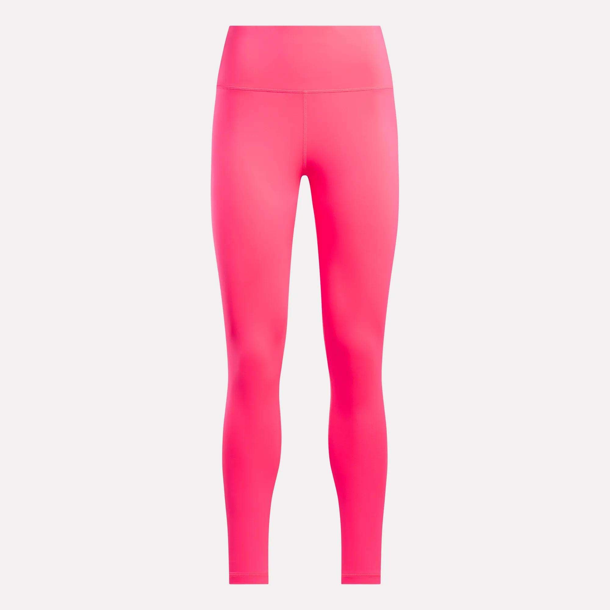 Bright pink Reebok Women's Core High-Rise Leggings displayed on a plain light background, front view. Made with RBK-DRY fabric for comfort and breathability; no visible branding or patterns.