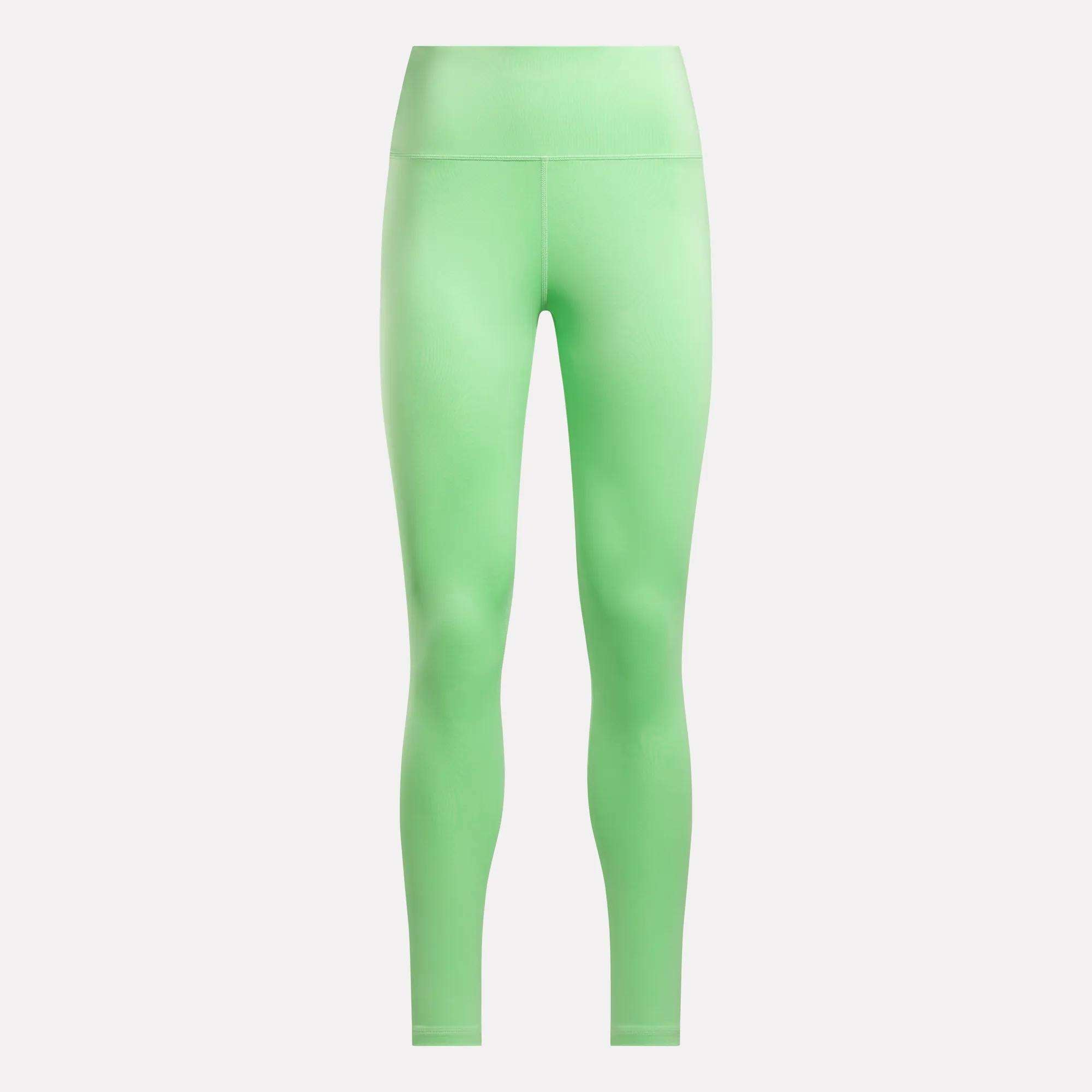 Reebok Women's Core High-Rise Leggings in bright green are made from RBK-DRY fabric, offering a smooth, seamless, full-length fit with no visible logos or patterns—ideal for workouts and daily wear.