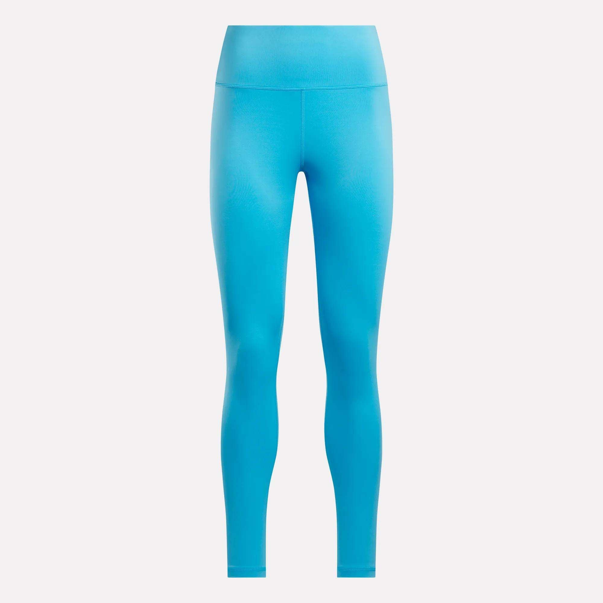 Reebok Women's Core High-Rise Leggings in bright blue are shown on a plain white background. These full-length cycling leggings feature smooth RBK-DRY fabric, a fitted silhouette, and no visible logos or patterns.