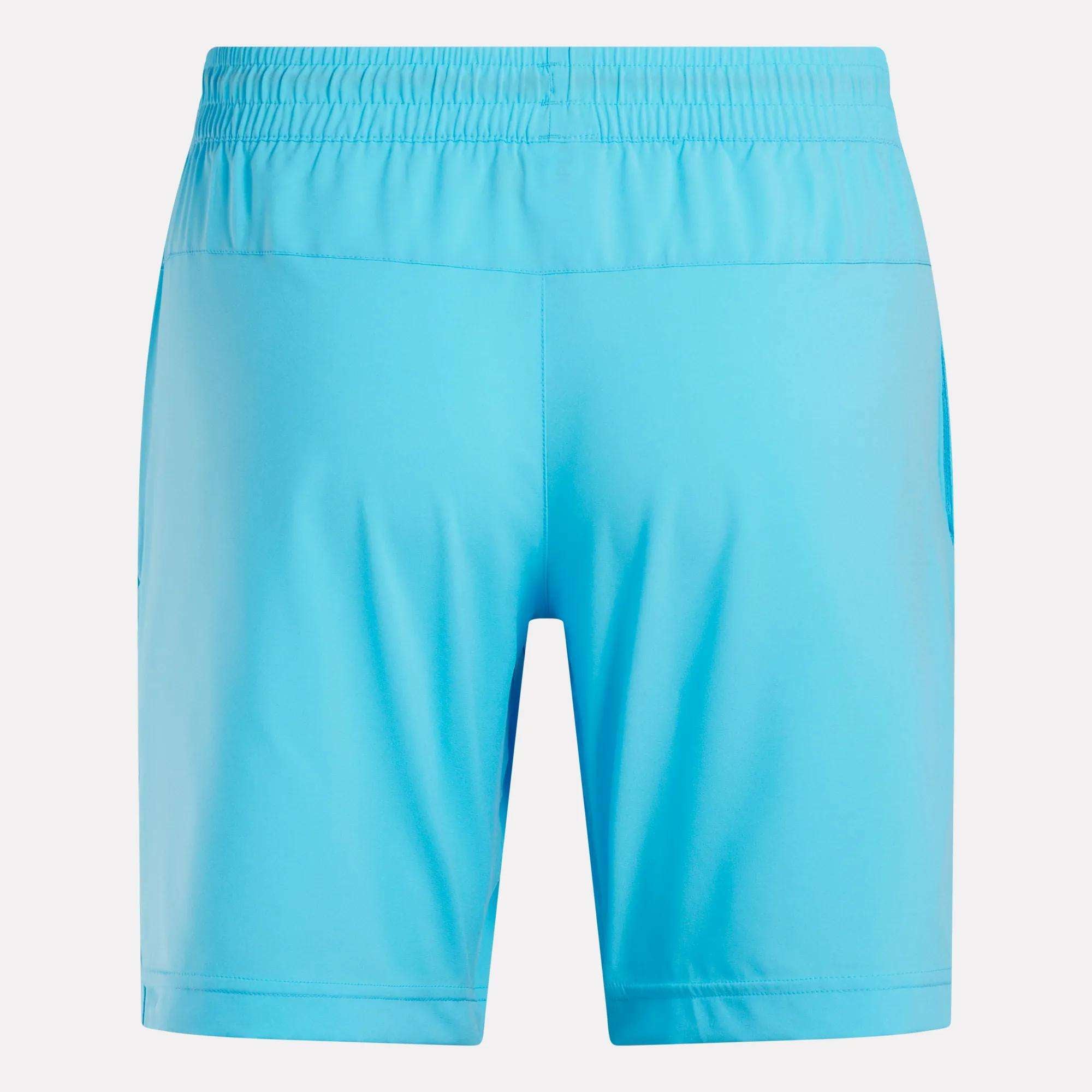 Reebok Men's Workout Ready Woven Shorts in light blue, shown from the back with an elastic waistband and no visible logos or patterns. These sweat-wicking shorts deliver breathable comfort for active days.