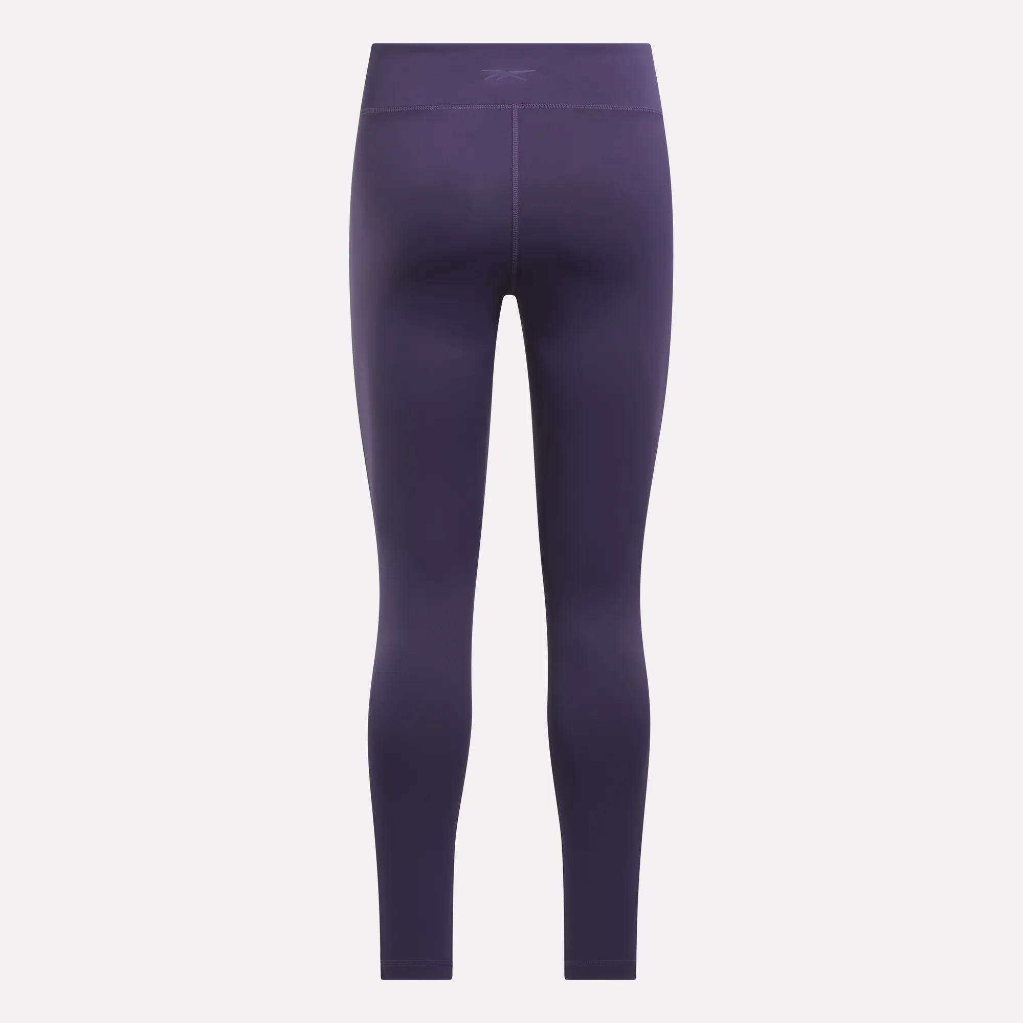 Reebok Women's Lux High-Rise Tights in purple shown from the back, highlighting their fitted design, subtle stitching, and moisture-wicking RBK-DRY fabric.