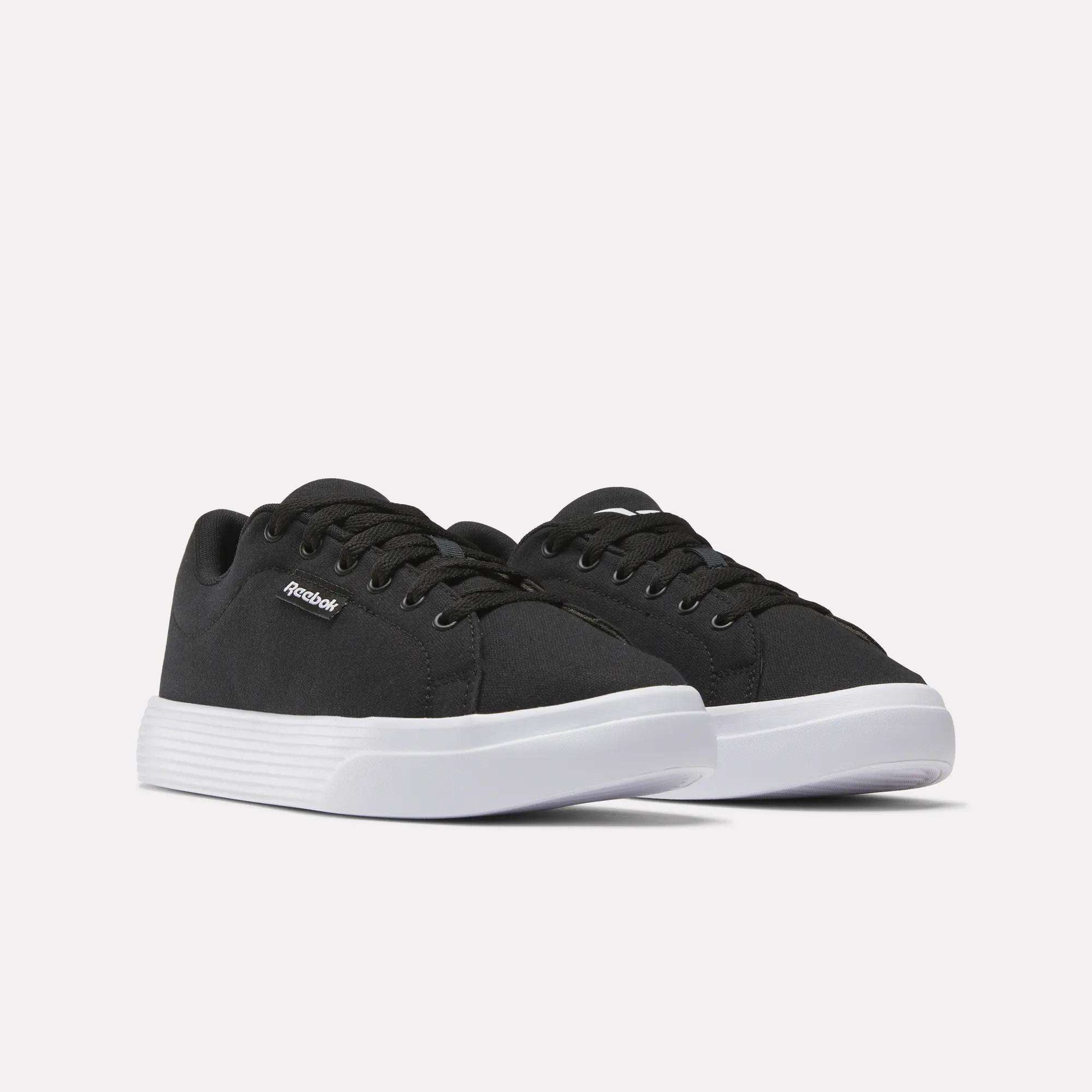 A pair of black Reebok Women's OnLux Court Lite Walking Shoes with white soles and black laces, side by side on a plain white background—ideal for anyone seeking comfortable walking shoes.