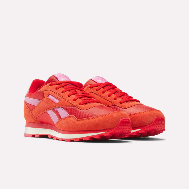 The Reebok Classic AZ Shoes for big kids feature red and pink suede and leather with pink side stripes and red laces—retro sneakers perfect for junior girls’ collections, shown on a white background.