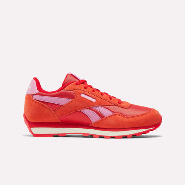 The Reebok Classic AZ Shoes for big kids feature a bright red retro design with pink side stripes and heel tab, lace-up closure, white midsole, and textured red outsole, shown against a plain white background.