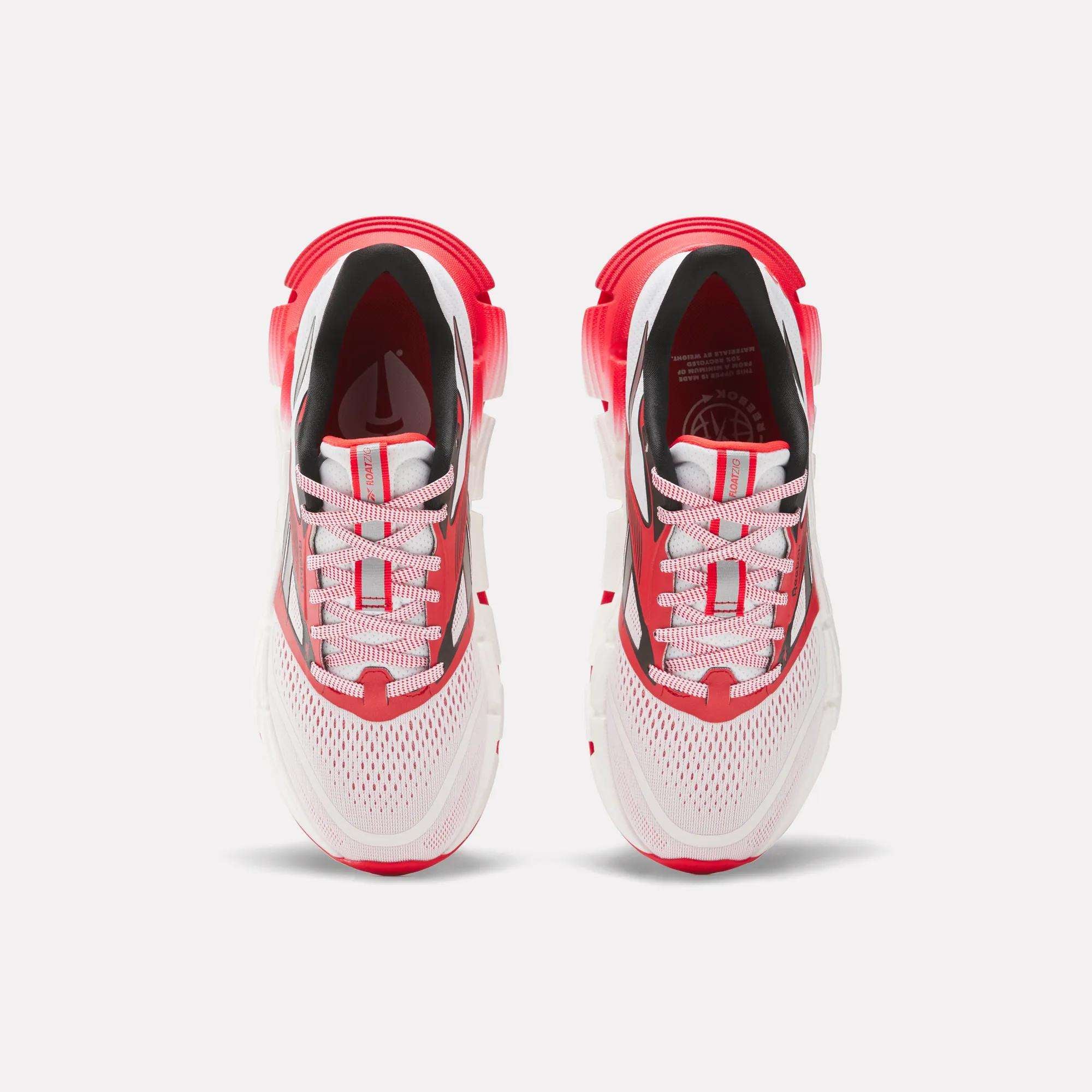 The Reebok Women's FloatZig 2 AHA Running Shoes feature a white mesh upper, red and black accents, white laces, and energy-returning cushioning for comfort and performance. Shown from above.