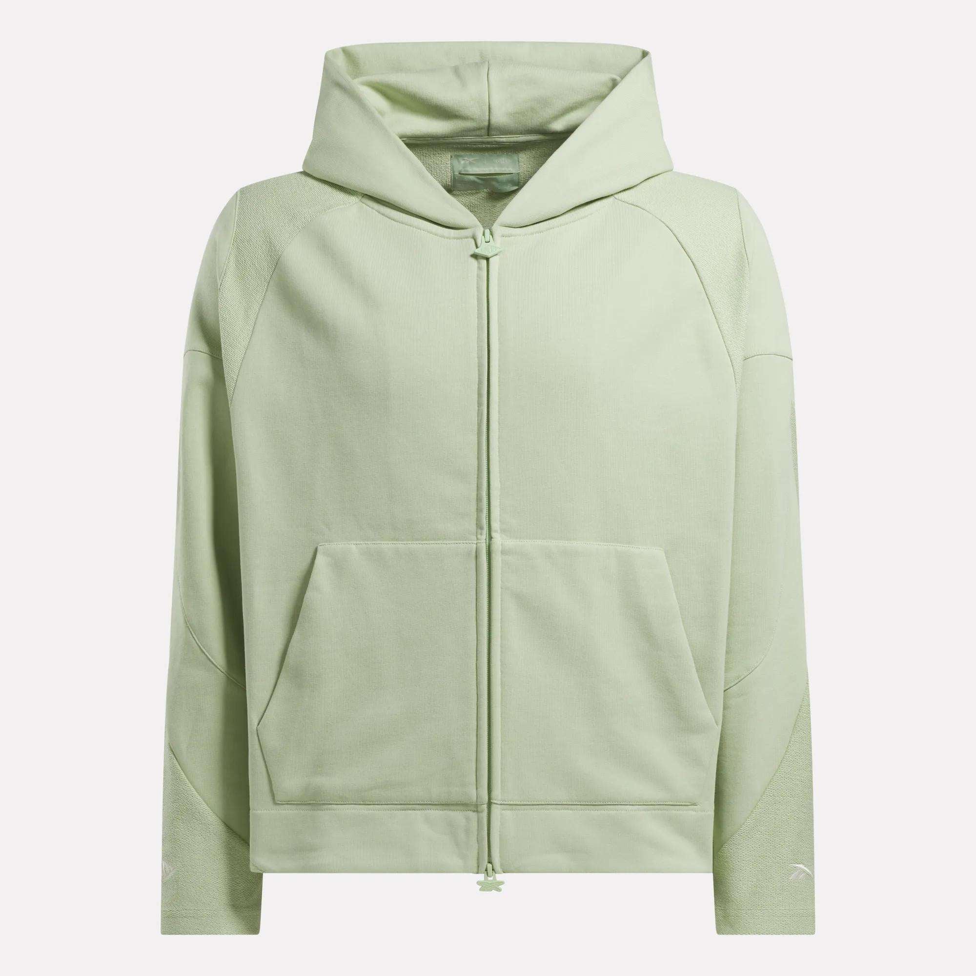 The Reebok x CHUKWU Full-Zip Hoodie by Reebok is a light green French terry hoodie with a front zipper, long sleeves, hood, and two front pockets, shown on a plain white background.