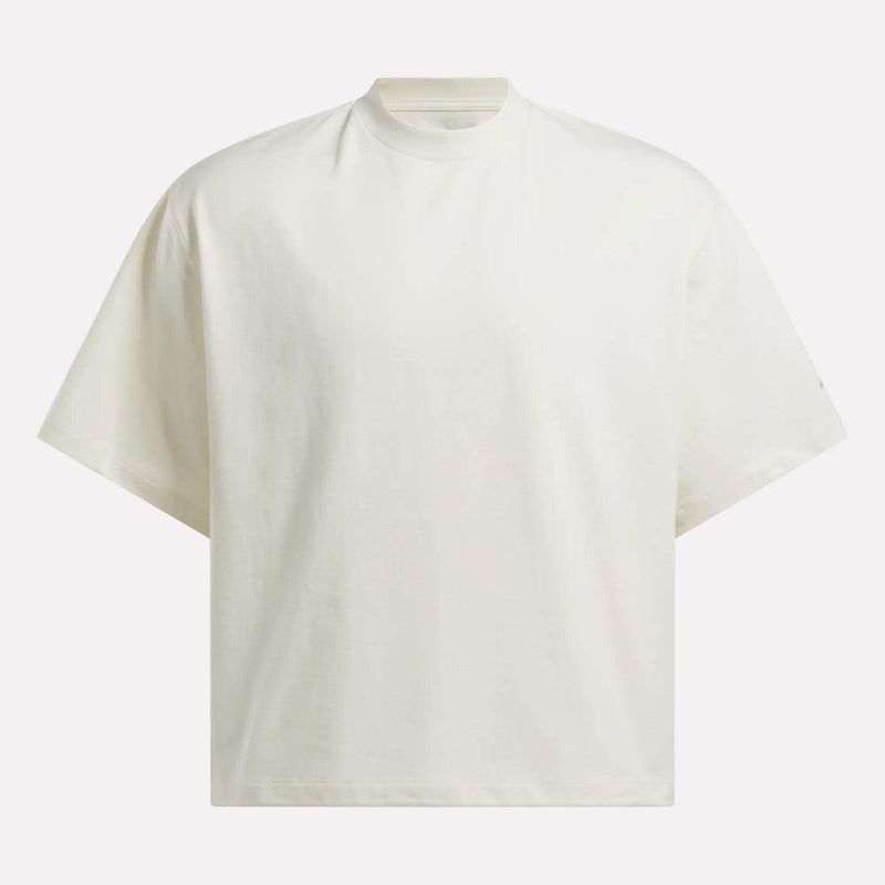 The Reebok x CHUKWU Tee by Reebok is an oversized white t-shirt with short sleeves and a high crew neckline, shown against a light background.