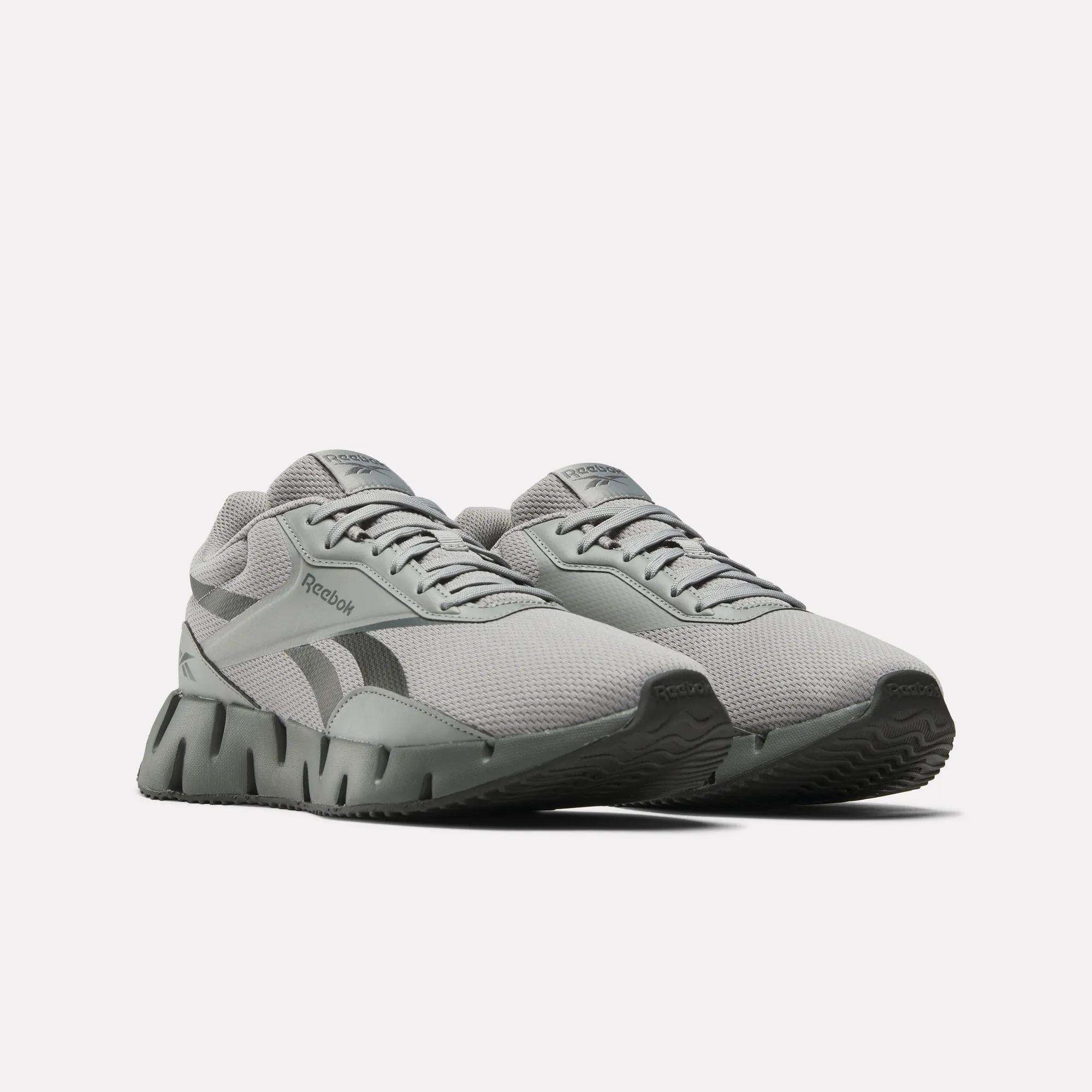 A pair of Reebok Zig Dynamica STR Shoes in light gray with a breathable mesh upper, black side logo, and chunky EVA-cushioned soles, displayed side by side from the front on a plain white background.