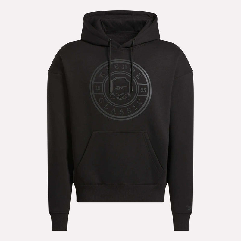 The Reebok Men's Crest Hoodie features a relaxed fit in black, soft fleece fabric, a front pocket, hood, and a subtle circular Reebok Classic logo with text on the chest.