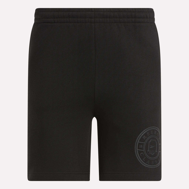 Men's Crest Shorts by Reebok: black relaxed fit cotton shorts for men with an elastic waistband and a subtle Classic logo near the hem. These shorts are plain, with no visible pockets or drawstrings.