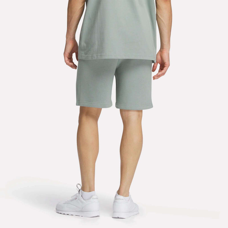 A man wearing Reebok Men's Crest Shorts and a t-shirt.