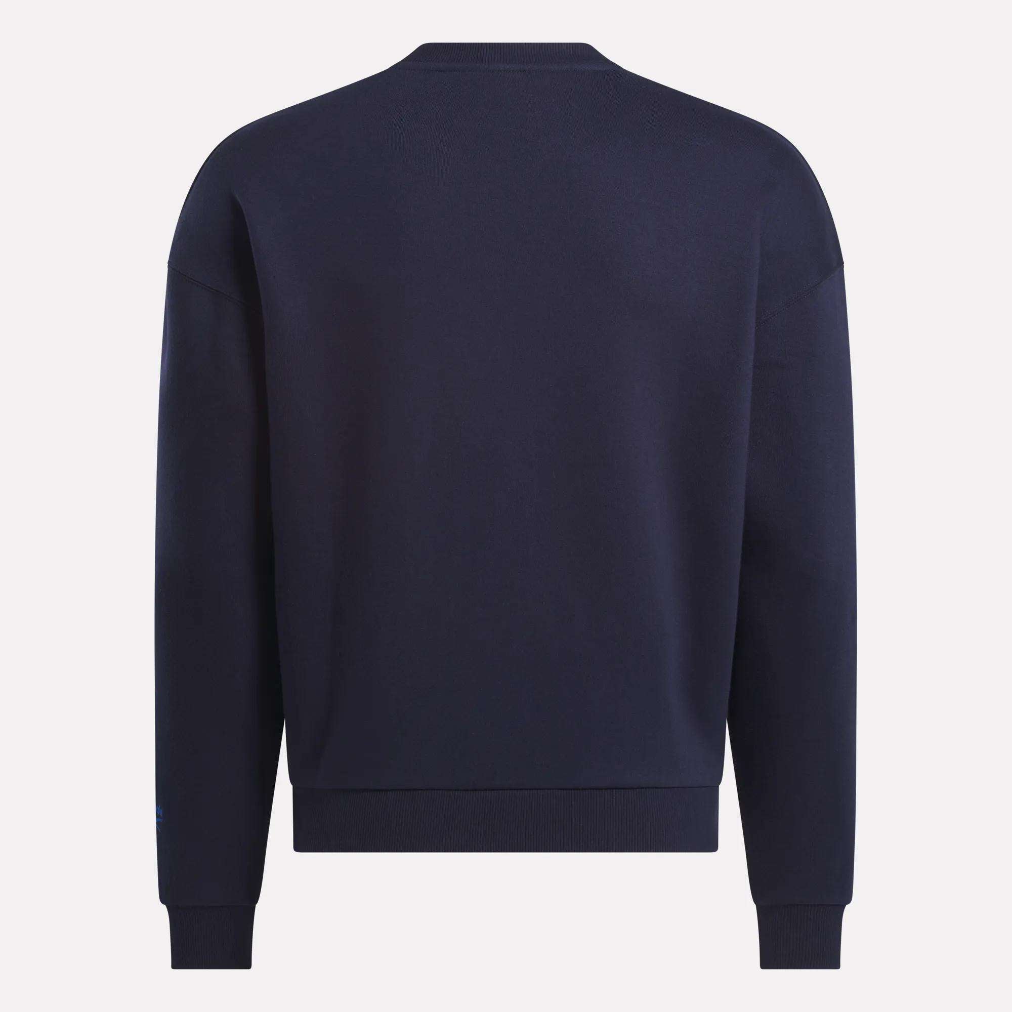 A Men's Crew Sweatshirt by Reebok in plain navy blue is shown from the back, featuring a classic crew neckline with ribbed cuffs and hem, set against a light background.