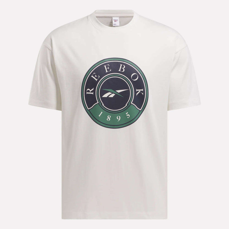 The Men's Lawn Club T-Shirt by Reebok is a white tee with a large circular Lawn Club logo on the chest, displaying "REEBOK," the brand emblem, and "1895" in black and green.