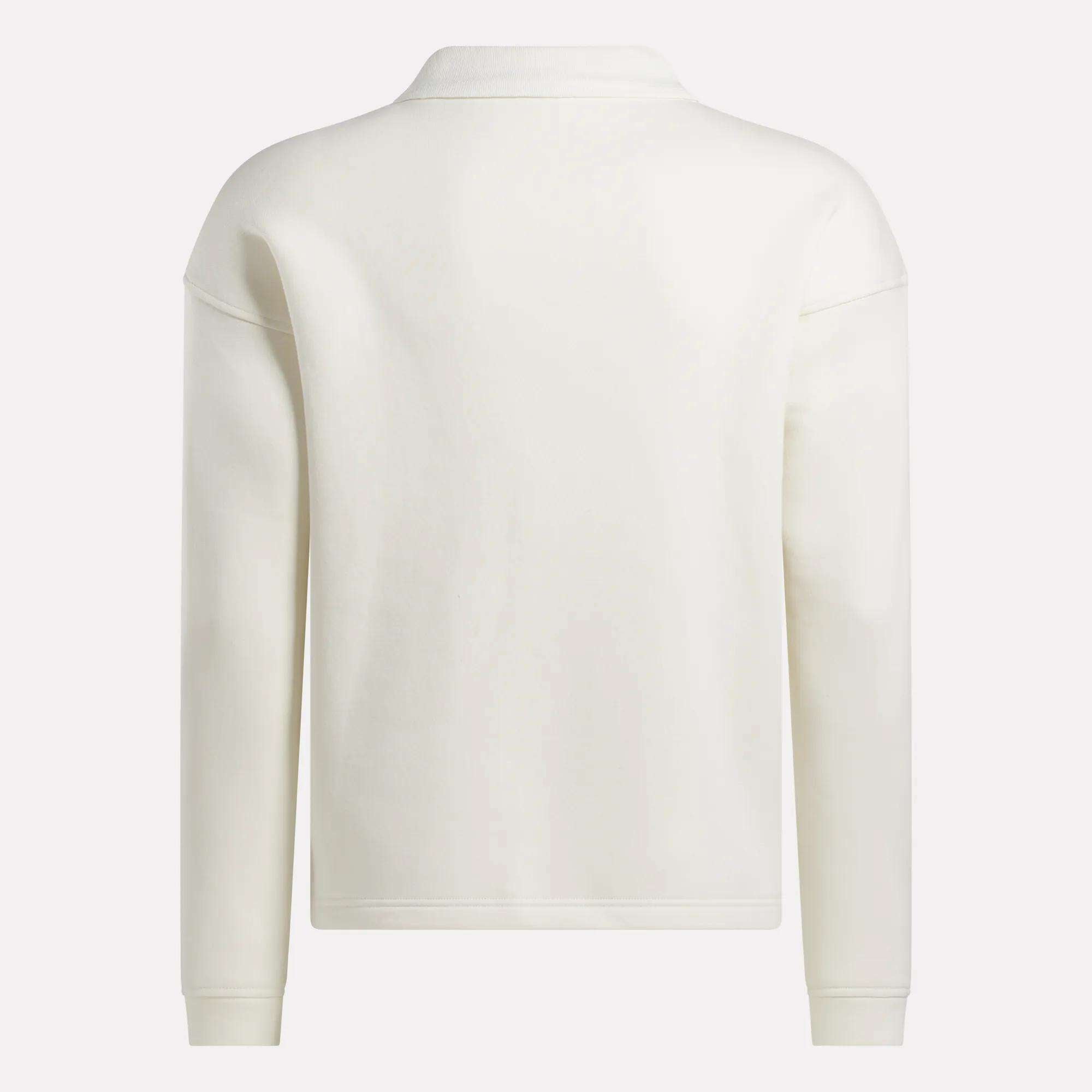The image shows the back of a Reebok Men's Wardrobe Essentials Long Sleeve Polo Shirt in plain white, featuring a simple, collarless design without visible patterns, logos, or embellishments.
