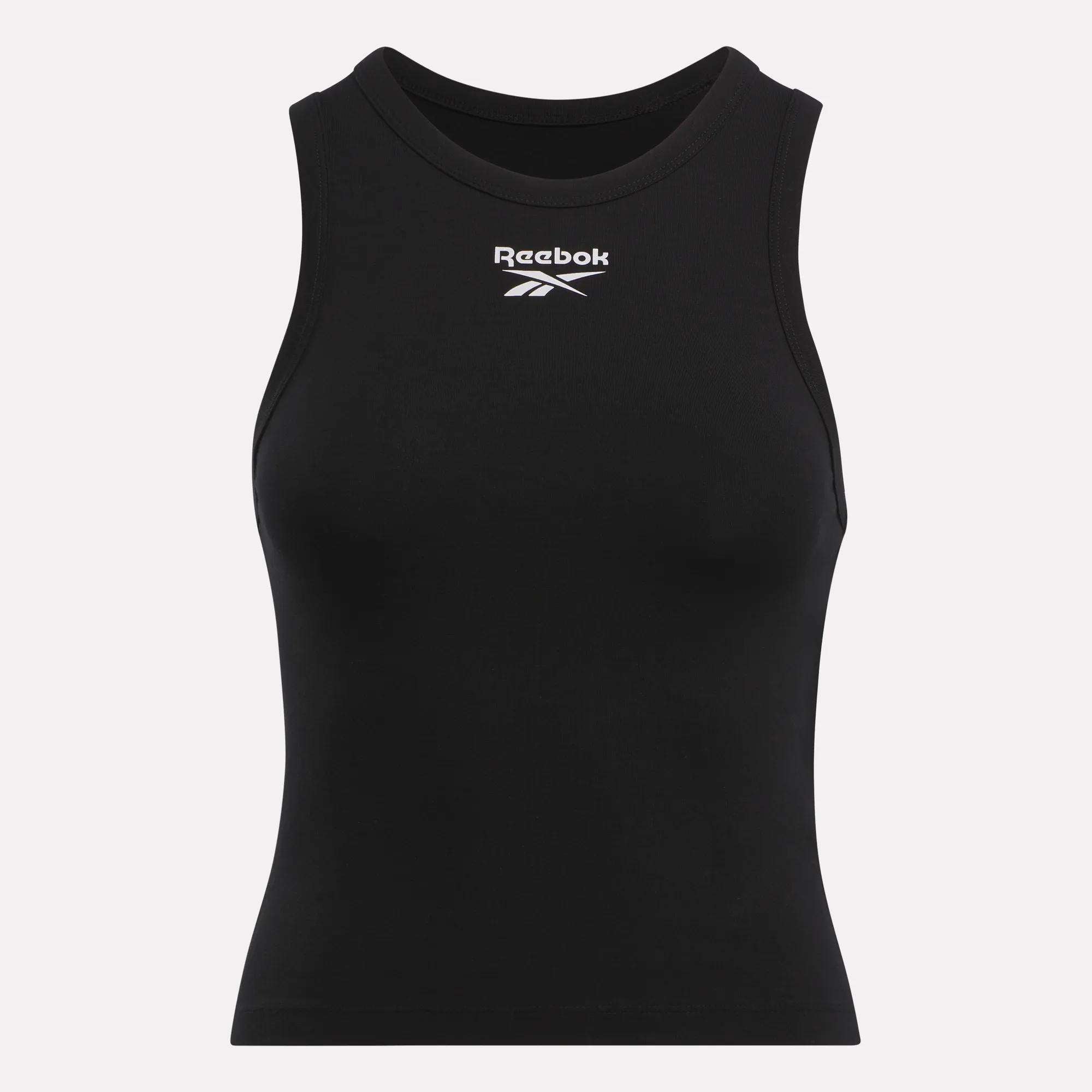 The Reebok Women's Rib Tank Top is sleeveless and black, made of soft cotton rib knit with a high neckline. The white Reebok logo and name are displayed on the chest against a plain, light-colored background.