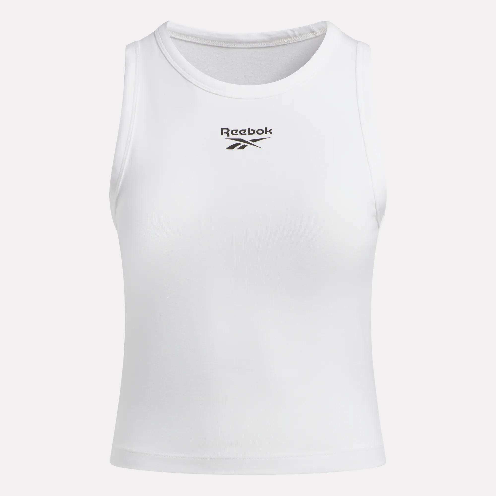 The Women's Rib Tank Top by Reebok is a sleeveless white top with the black Reebok logo and name on the chest, shown against a plain light background.