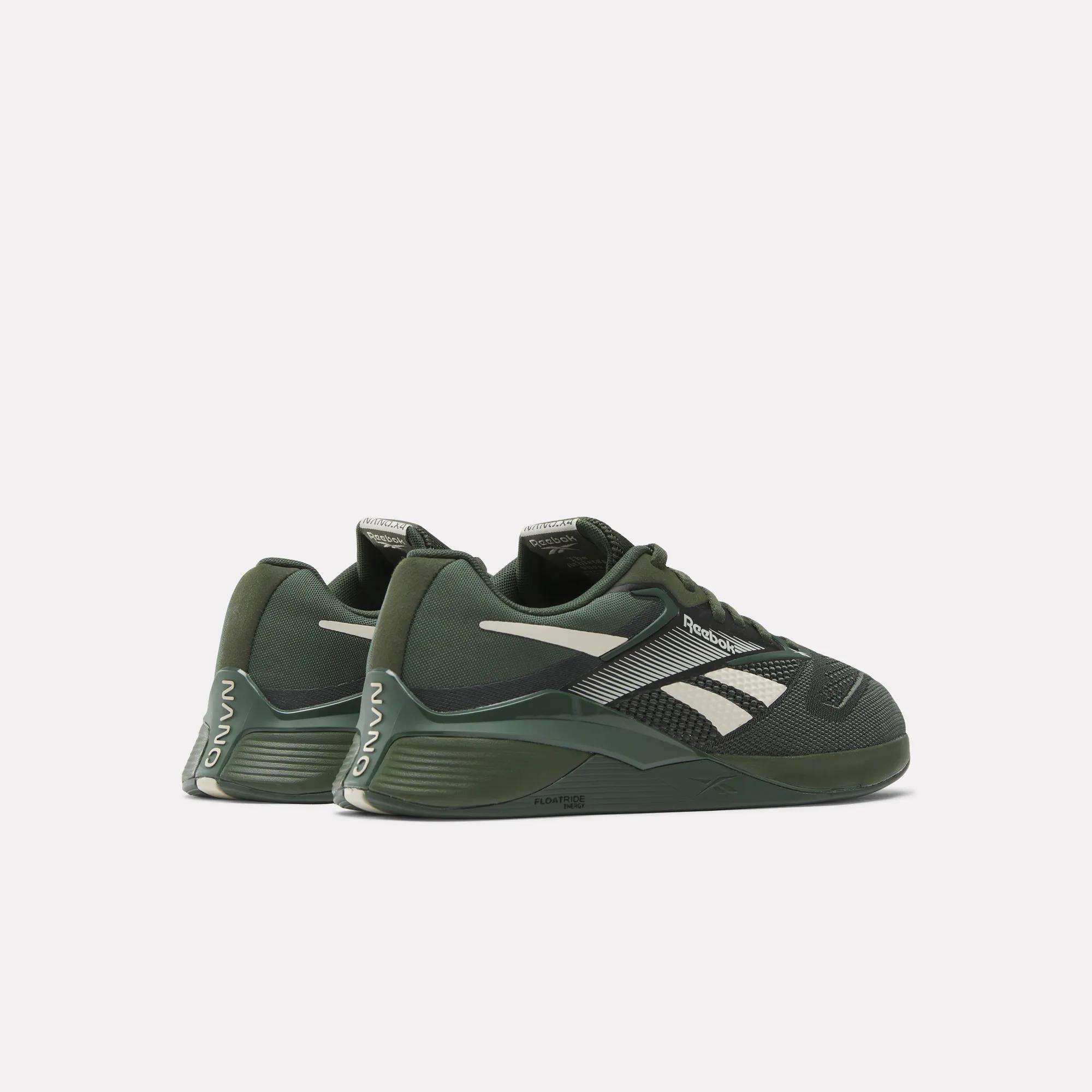 The Reebok Nano X4 Training Shoes in dark green with white accents feature the Reebok logo on the sides, Nano branding on the heel, and responsive Floatride Energy Foam cushioning, shown against a plain white background.