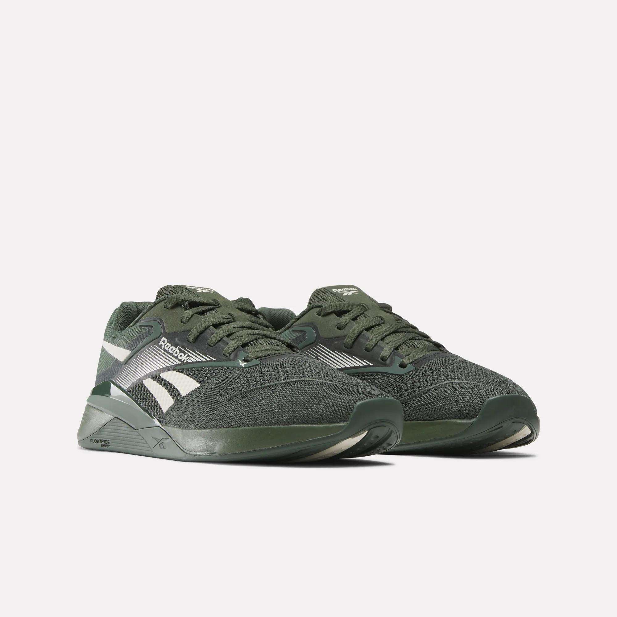 A pair of Reebok Nano X4 Training Shoes in dark green with white accents and laces, featuring Floatride Energy Foam, displayed against a plain white background.