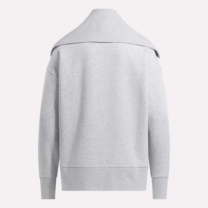 The Reebok Women's Wardrobe Essentials Retro Zip Top is shown from the back in light gray, featuring long sleeves, a wide folded collar, and ribbed cuffs and hem. The fleece fabric looks soft, cozy, and comfortable.