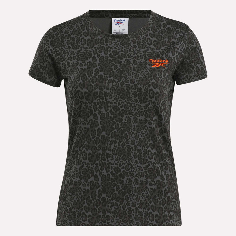 The Reebok Women's Leopard Print Baby T-Shirt features short sleeves, a bold black leopard print, and an orange logo on dark grey—ideal as a trendy mini tee.