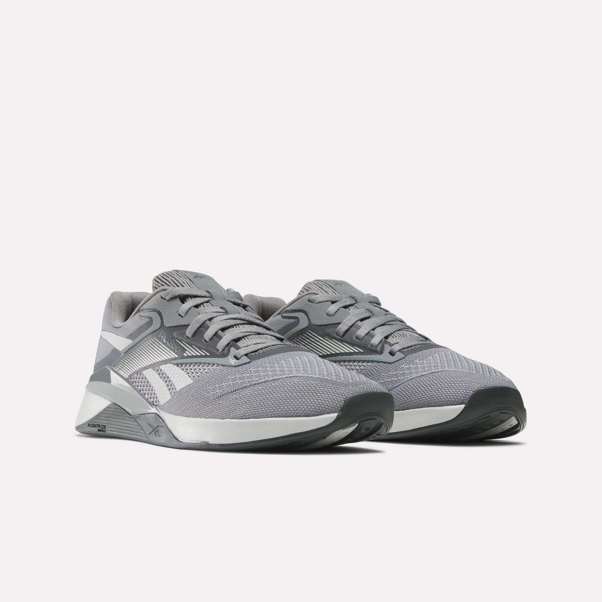 A pair of Reebok Nano X4 Training Shoes in gray with white accents and black soles, designed for versatile workouts, are displayed side by side on a light background.