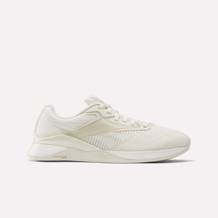 The Women's Nano X4 Training Shoes by Reebok are shown in cream, featuring a Flexweave upper, lace-up closure, and textured sole in a side view against a plain white background.