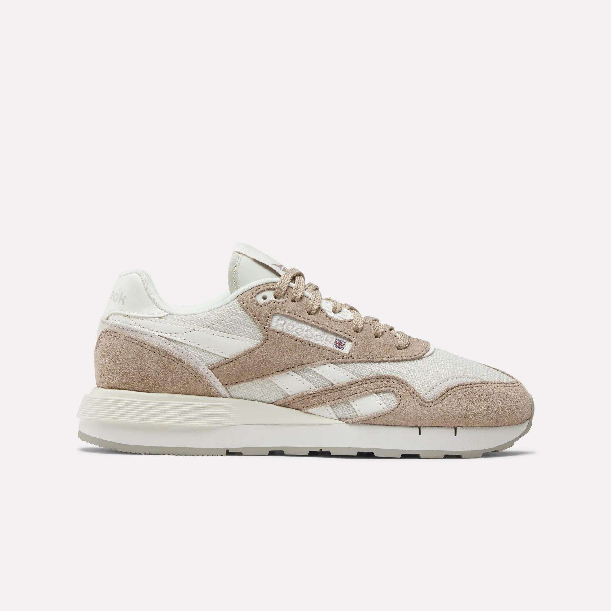The Women's Classic Nylon 89 Shoes by Reebok feature a retro beige and white design with suede and mesh panels, beige laces, a white sole, and the signature Reebok logo on the side, shown from a side view on a plain white background.