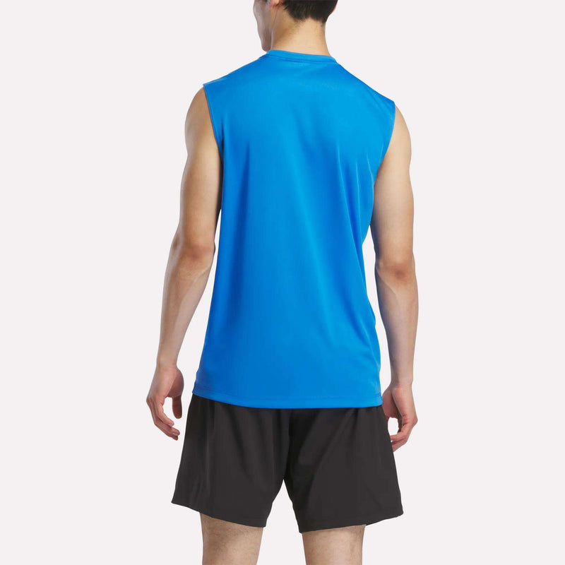 A man faces away from the camera, wearing a Reebok Men's Sleeveless Tech Training T-Shirt in bright blue and black athletic shorts, set against a plain white background.
