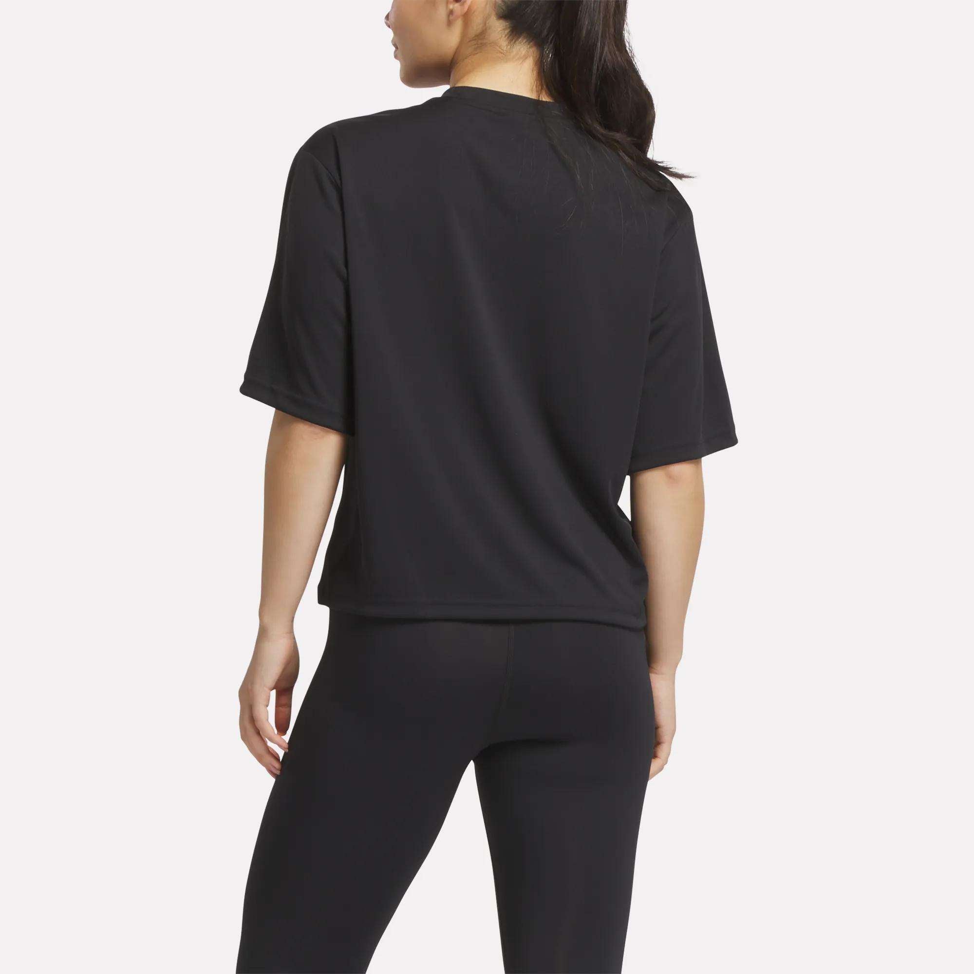 A woman models the Reebok Women's Basketball Mesh T-Shirt and black leggings, standing with her back to the camera against a plain white background.