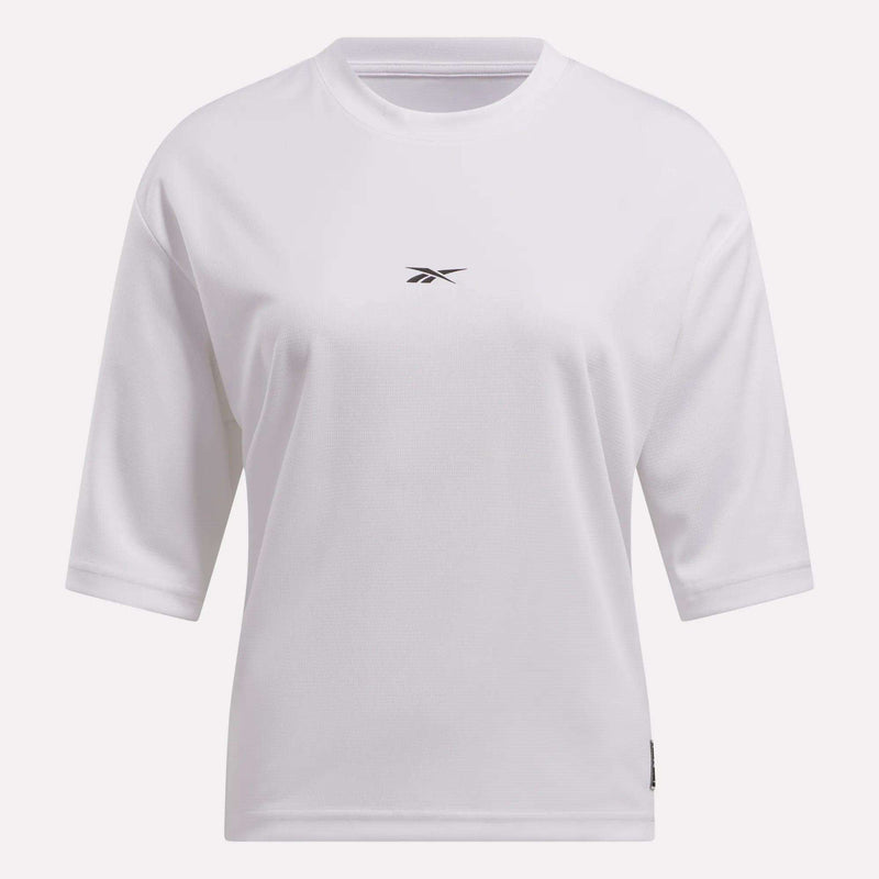 The Reebok Women's Basketball Mesh T-Shirt is a plain white crew neck tee with half sleeves and a small black logo centered on the chest, combining classic comfort and sporty style.