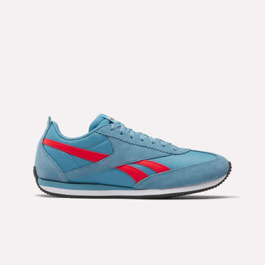 The Reebok R100 Shoes are light blue athletic sneakers inspired by '70s running style, featuring a red Reebok logo, white midsole, and black outsole, shown in side profile on a plain white background.
