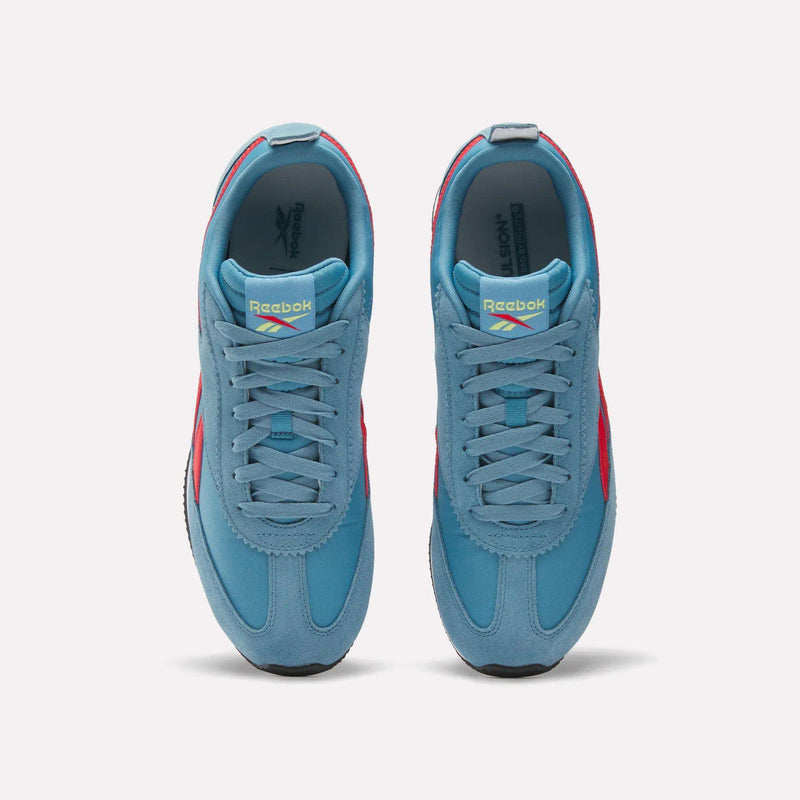 A top view of Reebok R100 Shoes in light blue with red accents and white soles. These low-profile sneakers feature laces and the Reebok logo on the tongue, inspired by classic 1970s running style.