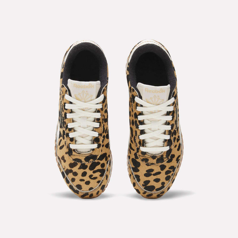 A pair of Women's Classic AZ Shoes by Reebok with white laces and a striking brown and black animal print, seen from above against a plain white background.